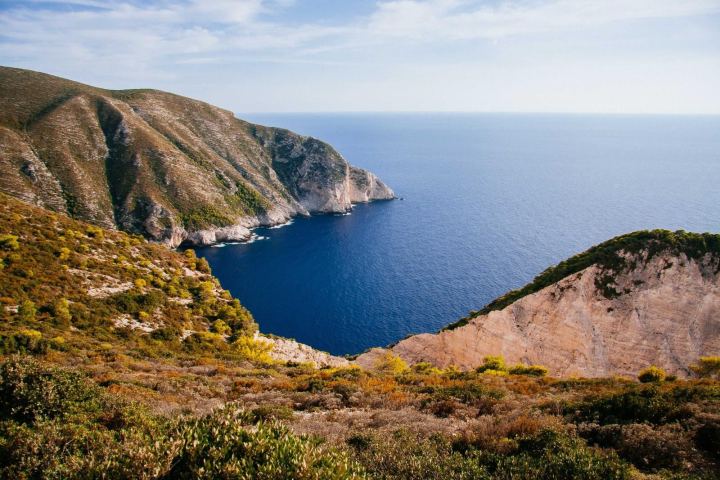 A green headland above a deep blue sea