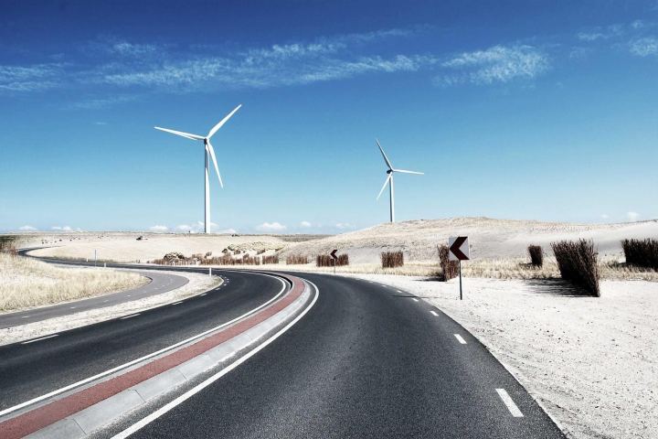 Wind turbines beside a coastal road