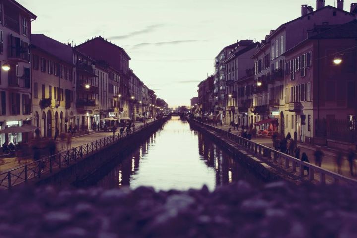 A canal lined with tall buildings at dusk