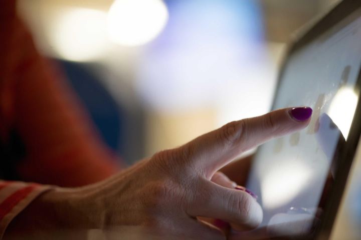 A finger tapping a tablet screen