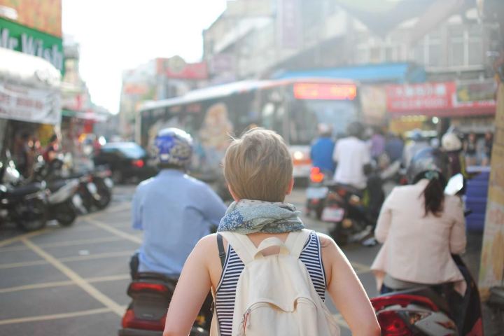 Pedestrians and scooters on a busy market street