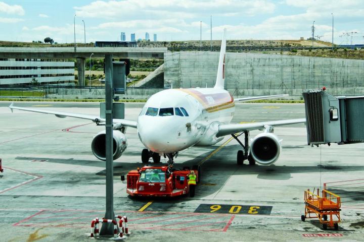 A passenger jet parked at an airport gate