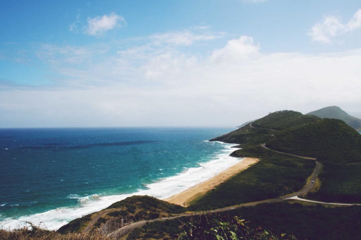 A curving beach and headland seen from above