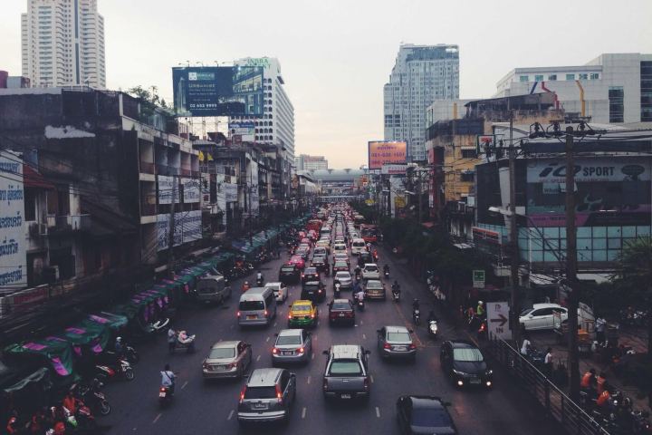 Traffic on a wide avenue between city towers