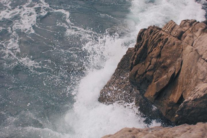 Waves crashing against coastal rocks